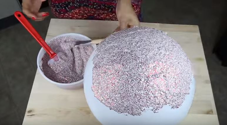 Gonfia un palloncino e lo ricopre di glitter, il risultato è strabiliante